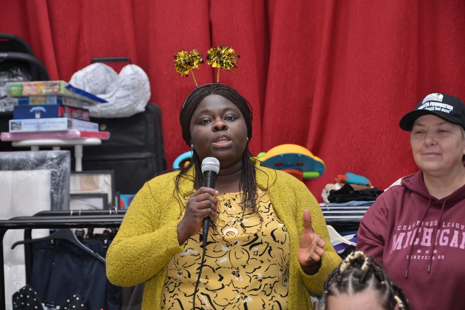 Woman speaking at microphone at event