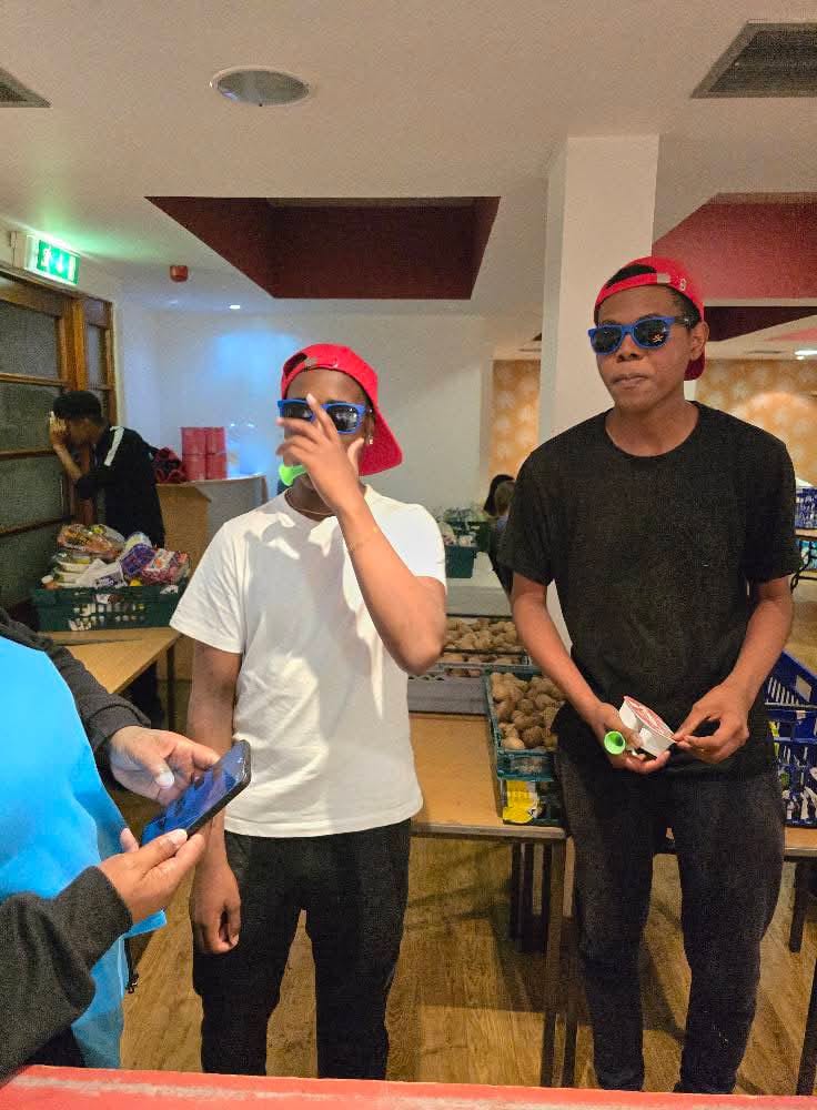 Young people wearing sunglasses at indoor event