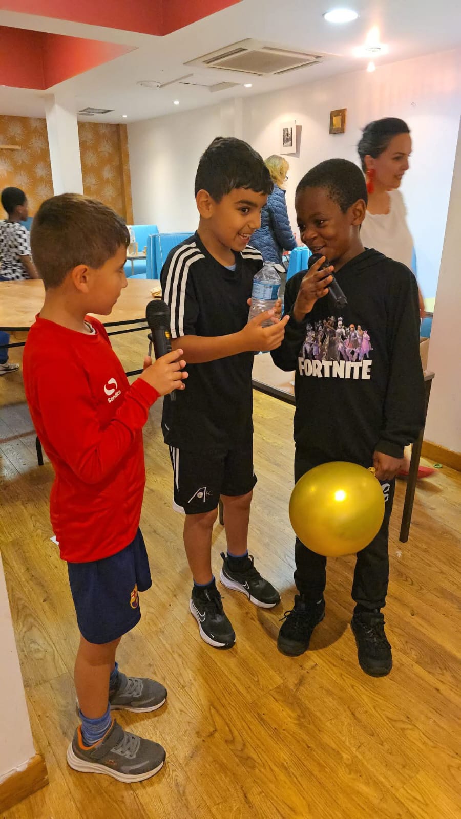 Children with microphones at community event