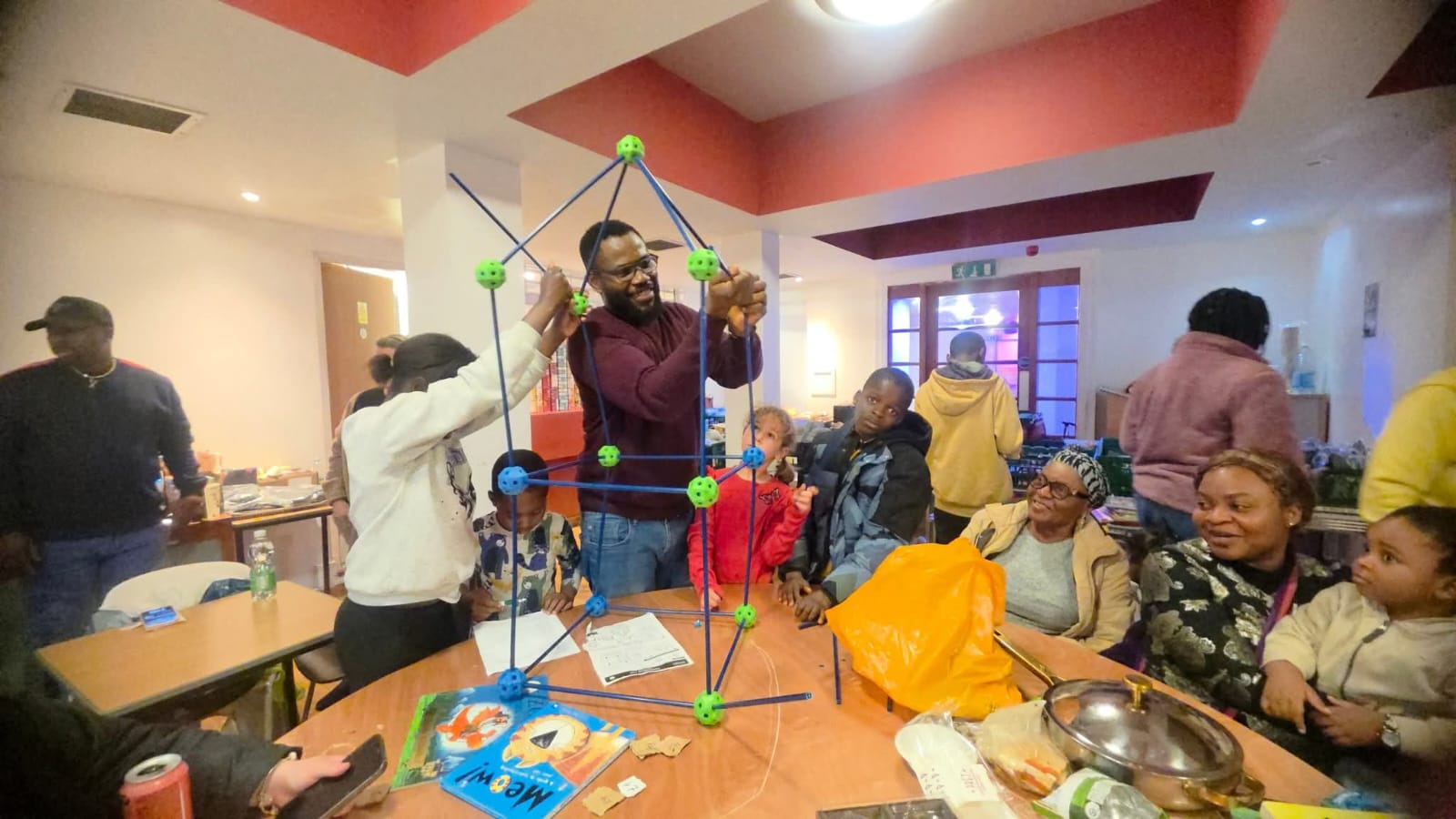 Group of people at community event with geometric structures